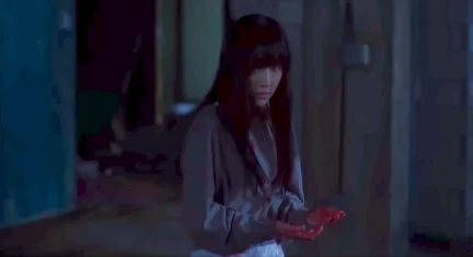 Ha-bin with her hands drenched in blood