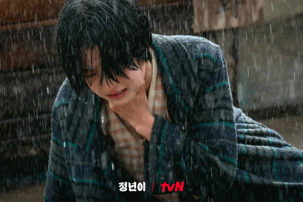 Kim Tae-ri, holding her neck, frustrated and crying due to her voice.
